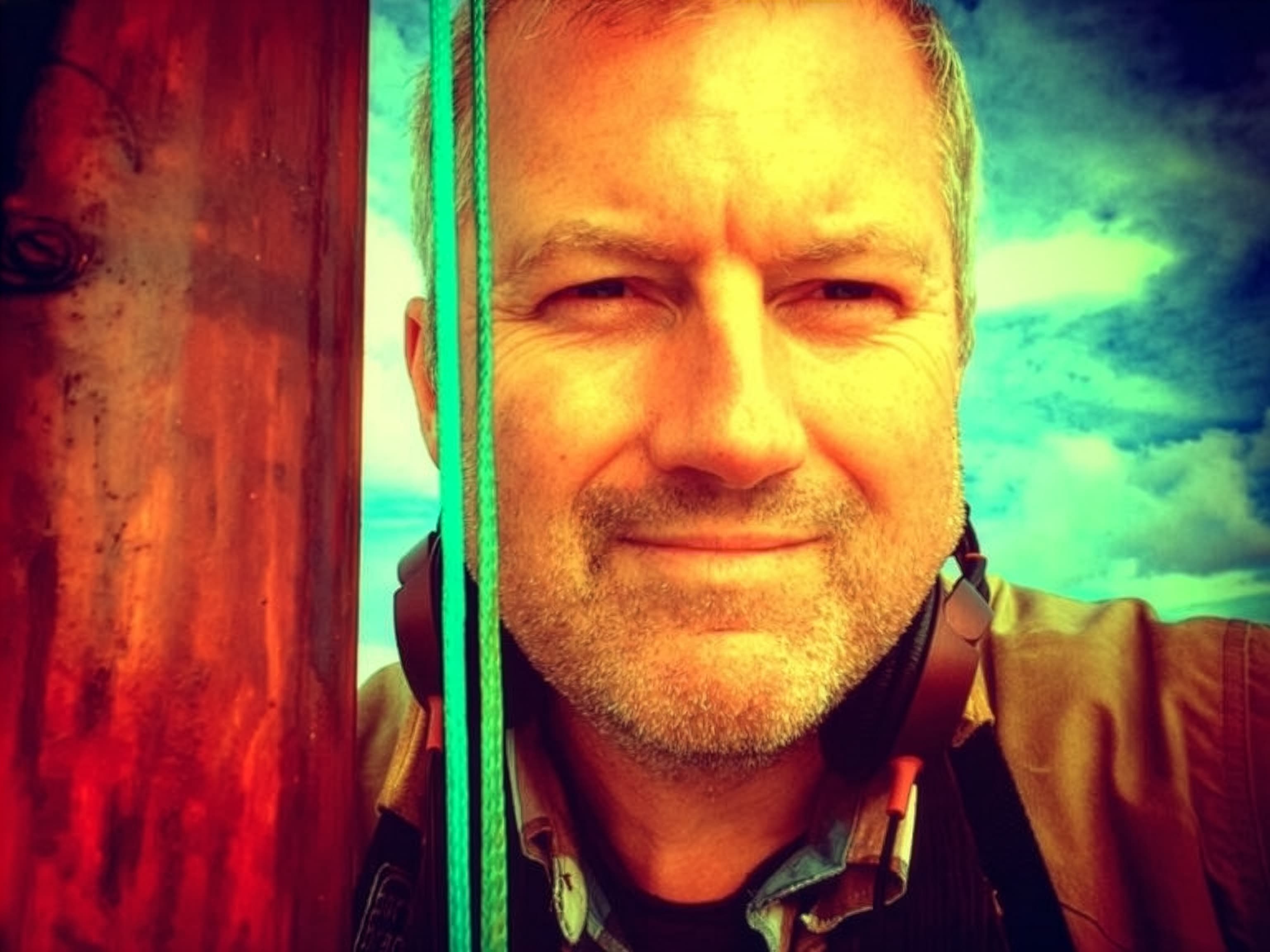 Director Philip John in lurid colour against a dramatic sky